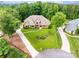 Expansive home surrounded by lush landscaping, a circular driveway and ample parking at 148 Castle Dr, Mooresville, NC 28117