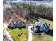 Aerial view of two luxury homes showcasing well-manicured lawns, lush landscaping, and lake in the background at 148 Castle Dr, Mooresville, NC 28117