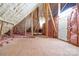 Bright attic space with insulation and unfinished flooring, perfect for storage at 148 Castle Dr, Mooresville, NC 28117