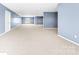 Open basement area with soft carpeting and natural light coming from the windows at 148 Castle Dr, Mooresville, NC 28117