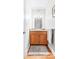 Cozy powder room featuring wood vanity, granite countertop, and decorative lighting at 148 Castle Dr, Mooresville, NC 28117