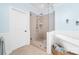 Bathroom featuring a glass-enclosed shower, soaking tub, and classic design elements with wainscoting at 148 Castle Dr, Mooresville, NC 28117