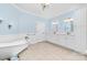 Bathroom featuring a soaking tub, dual sink vanity, wainscoting, and classic fixtures, creating a serene space at 148 Castle Dr, Mooresville, NC 28117