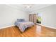 Bedroom featuring hardwood floors, ceiling fan, and sliding glass door at 148 Castle Dr, Mooresville, NC 28117