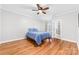 Light bedroom with hardwood flooring, ceiling fan, and natural light at 148 Castle Dr, Mooresville, NC 28117