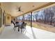 An expansive covered patio area offering outdoor seating with views of the backyard and wooded area at 148 Castle Dr, Mooresville, NC 28117
