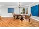 Dining room with hardwood floors, chandelier, and a large window offering natural light and outdoor views at 148 Castle Dr, Mooresville, NC 28117