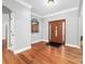 Foyer with hardwood floors, paneled wood front door, and decorative mirror at 148 Castle Dr, Mooresville, NC 28117