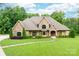 Charming stone-accented home featuring a meticulously manicured lawn and mature landscaping at 148 Castle Dr, Mooresville, NC 28117