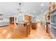 Open concept kitchen with wood cabinetry, granite countertops, and a view to living room at 148 Castle Dr, Mooresville, NC 28117