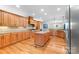 Spacious kitchen featuring custom wood cabinets, granite countertops, and stainless steel appliances at 148 Castle Dr, Mooresville, NC 28117