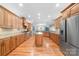 Spacious kitchen featuring custom wood cabinets, granite countertops, and stainless steel appliances at 148 Castle Dr, Mooresville, NC 28117