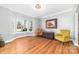 Living room with wood flooring, large bay windows, neutral paint, and elegant furnishings at 148 Castle Dr, Mooresville, NC 28117