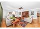 Spacious living room featuring hardwood floors, a decorative rug, wood burning fireplace, and custom built-in media center at 148 Castle Dr, Mooresville, NC 28117
