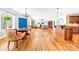 Open-concept living room with hardwood floors, fireplace, dining area, and kitchen island, perfect for entertaining at 148 Castle Dr, Mooresville, NC 28117