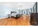 Main bedroom features hardwood floors, ceiling fan, and a bay window that provides natural light and scenic views at 148 Castle Dr, Mooresville, NC 28117