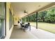 Covered patio with outdoor seating provides a relaxing view of the backyard at 148 Castle Dr, Mooresville, NC 28117