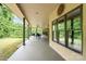 Covered patio with outdoor ceiling fan provides a relaxing view of the backyard at 148 Castle Dr, Mooresville, NC 28117