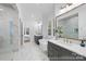 Bright bathroom with dual vanities, soaking tub, glass walk-in shower, marble floors and a bedroom view at 19155 Newburg Hill Rd, Davidson, NC 28036