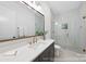 Bathroom with glass shower door, square sink and mirror with bronze accents and light at 19155 Newburg Hill Rd, Davidson, NC 28036