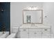 This elegant bathroom has a vanity with stone countertop, stylish fixtures and a tiled shower-tub combo at 19155 Newburg Hill Rd, Davidson, NC 28036