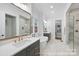 Bright bathroom features dual sinks, soaking tub, walk-in shower, marble floors, and a spacious walk-in closet at 19155 Newburg Hill Rd, Davidson, NC 28036