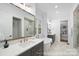 Bright bathroom features a soaker tub, dual vanities, and a glass shower with modern fixtures at 19155 Newburg Hill Rd, Davidson, NC 28036