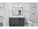 This modern bathroom features a vanity with a stone countertop, a toilet, and glass-door shower at 19155 Newburg Hill Rd, Davidson, NC 28036