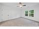 Bedroom features neutral walls, carpet floors, and a ceiling fan with natural light from a window at 19155 Newburg Hill Rd, Davidson, NC 28036