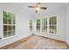 Sun-drenched bedroom with large windows offering a scenic view of the outdoors and hardwood floors at 19155 Newburg Hill Rd, Davidson, NC 28036