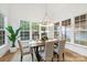 Sun-drenched dining room featuring hardwood floors, large windows, and an elegant chandelier at 19155 Newburg Hill Rd, Davidson, NC 28036