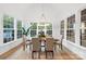 Bright dining room surrounded by large windows and a modern light fixture at 19155 Newburg Hill Rd, Davidson, NC 28036