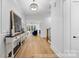Bright foyer with wood floors, stylish console table, and an open view to the living area at 19155 Newburg Hill Rd, Davidson, NC 28036
