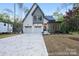 Charming two-story home with white brick, two-car garage, manicured lawn and beautiful landscaping at 19155 Newburg Hill Rd, Davidson, NC 28036