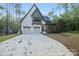 Charming two-story home with white brick, two-car garage, manicured lawn and lush landscaping at 19155 Newburg Hill Rd, Davidson, NC 28036