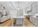 Open-concept kitchen featuring a large island with seating, stainless steel appliances, and modern finishes at 19155 Newburg Hill Rd, Davidson, NC 28036