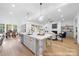 Open concept kitchen with large central island, stainless steel appliances, and hardwood flooring at 19155 Newburg Hill Rd, Davidson, NC 28036