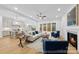 Open living area with fireplace, hardwood floors, and a seamless connection to the modern kitchen at 19155 Newburg Hill Rd, Davidson, NC 28036
