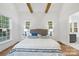 Bright main bedroom features hardwood flooring, large windows, and vaulted ceilings at 19155 Newburg Hill Rd, Davidson, NC 28036