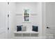 Bright mudroom with bench, storage cubbies, and a window with a view of the lake at 19155 Newburg Hill Rd, Davidson, NC 28036