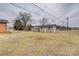Spacious backyard featuring two outbuildings, providing ample storage and workspace at 2004 Grandhaven Dr, Concord, NC 28027