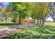 Well-maintained brick ranch with a large front yard and mature trees, offering curb appeal and a sense of privacy at 2004 Grandhaven Dr, Concord, NC 28027