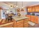 Open kitchen with island, brick accent wall, and dining area at 2004 Grandhaven Dr, Concord, NC 28027