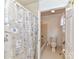 Bright bathroom with a shower-tub combo and tile flooring with a decorative shower curtain at 2050 Tite Rd, Stanfield, NC 28163