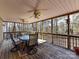 Relaxing covered porch with outdoor seating, ceiling fans, and view of wooded backyard at 2050 Tite Rd, Stanfield, NC 28163