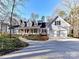 Beautiful home featuring a well-manicured lawn, circular driveway, attached garage, and covered front porch at 2050 Tite Rd, Stanfield, NC 28163