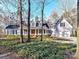 Charming two-story home featuring mature trees, a manicured lawn, and an attached two-car garage at 2050 Tite Rd, Stanfield, NC 28163