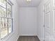 Neutral hallway bathed in natural light from the window near a white paneled door at 2050 Tite Rd, Stanfield, NC 28163