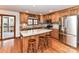 Well-designed kitchen with stainless steel appliances, granite countertops, a center island, and hardwood floors at 2050 Tite Rd, Stanfield, NC 28163