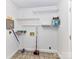 Practical laundry area with ample shelving, tile floor and good lighting at 2050 Tite Rd, Stanfield, NC 28163